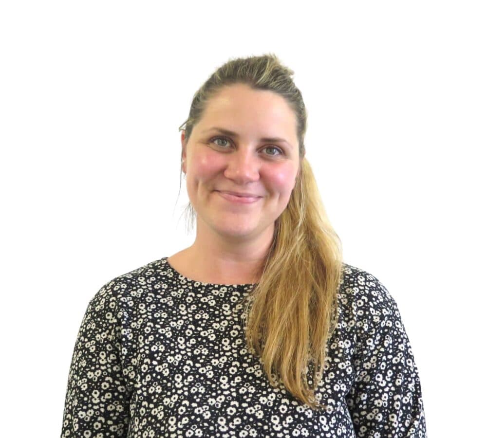 A woman with lon hair smiling and happy