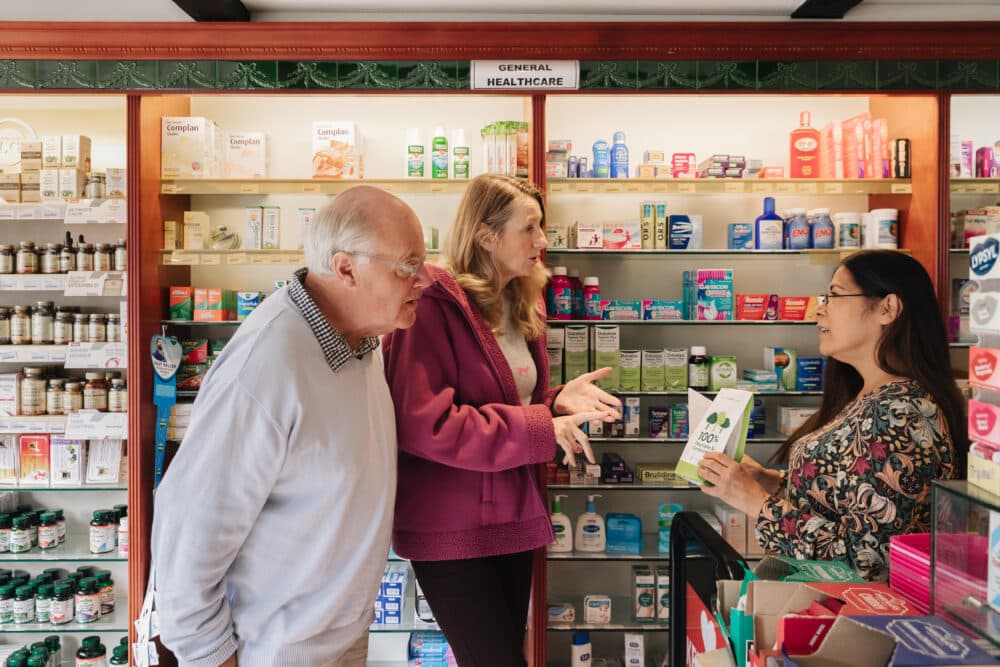 Elderly man with daughter at pharmacy