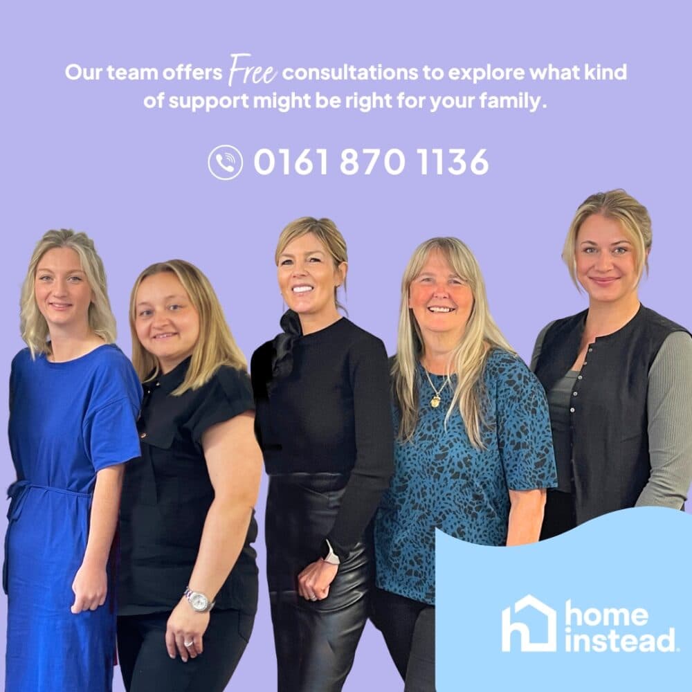 Five smiling women stand in a row in front of a purple background with Home Instead contact details. - Home Instead