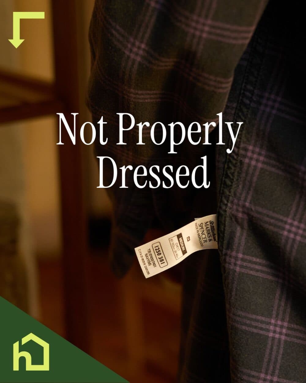 A shirt worn inside out, showing the clothing tag, with text reading "Not Properly Dressed. - Home Instead