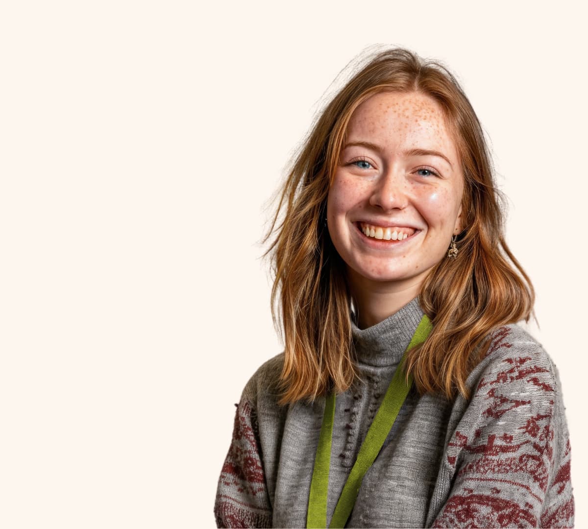 A woman with brown curly hair happy and smiling