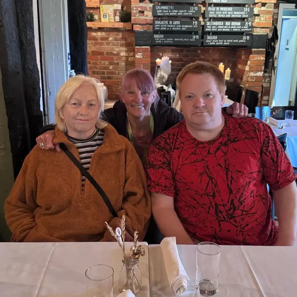 Home Instead Farnborough client Vivian enjoying a meal out with family and her care pro