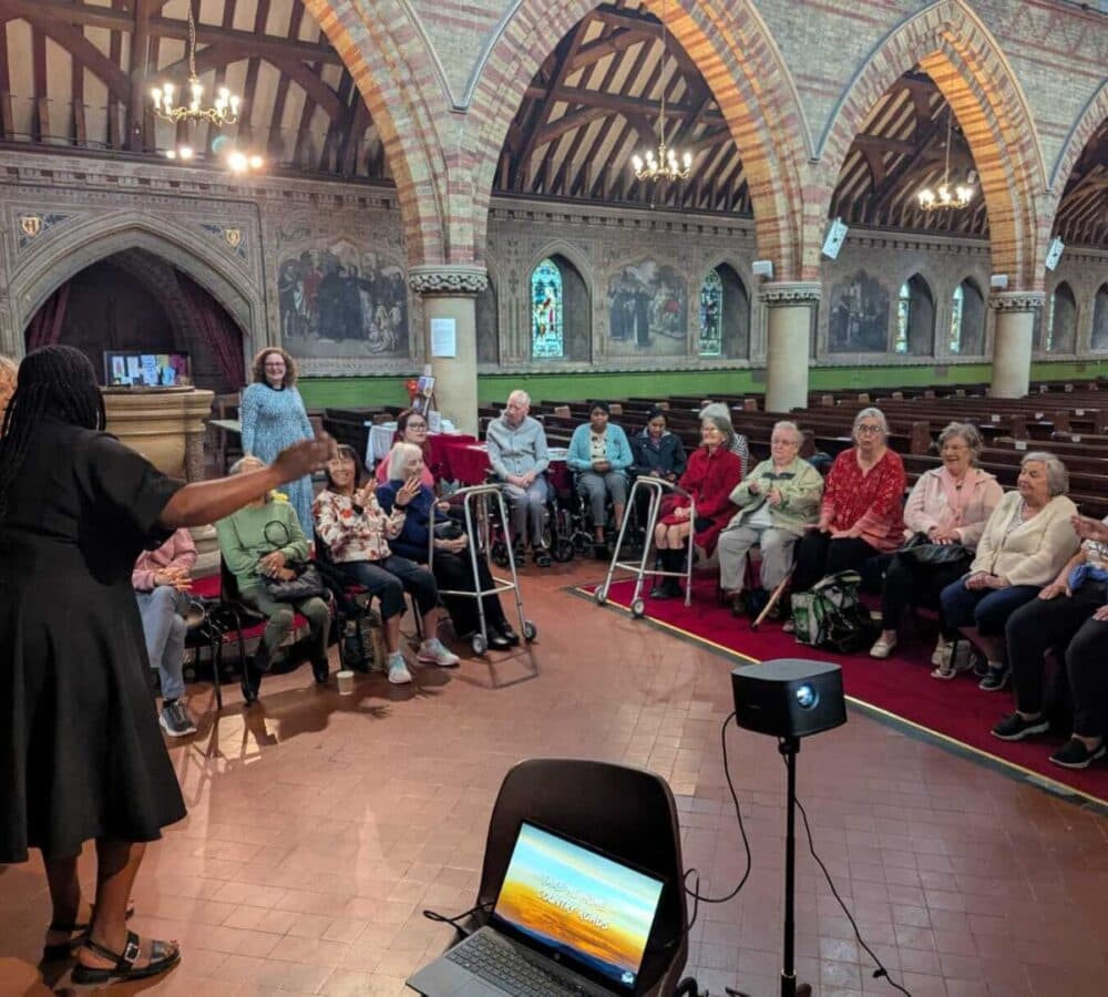 Older adults singing together inside the hall