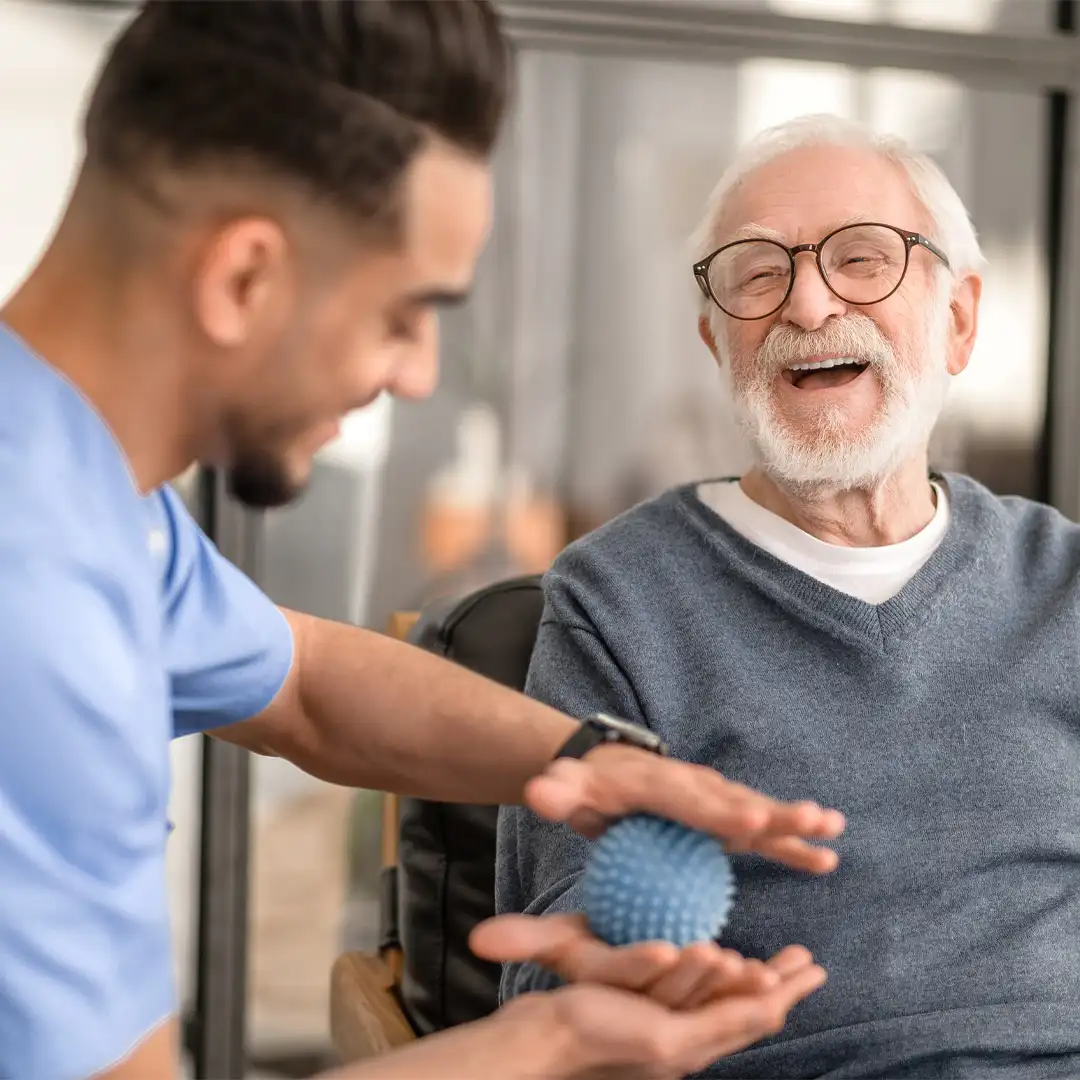 Physio supporting an older client with after stoke home care exercises