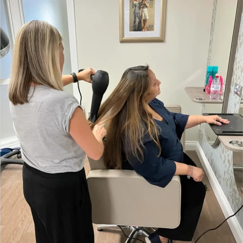 Louise blow drying a clients hair