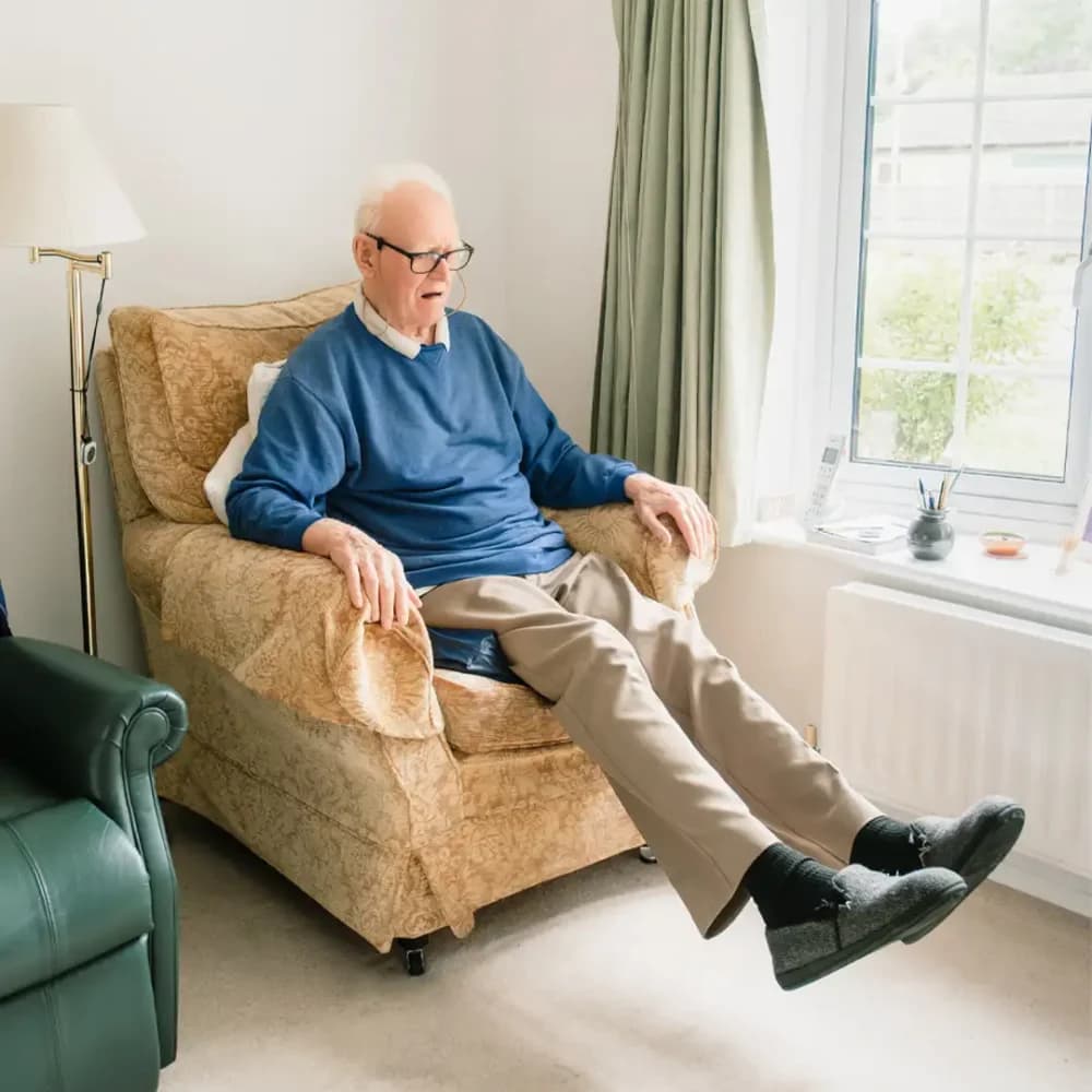 Home Instead Farnborough client Don L. completing his daily seated exercises with support from his live in care pro