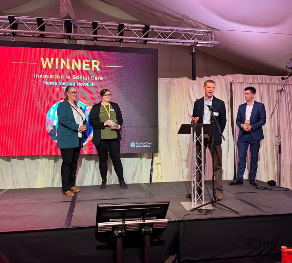 Accepting an award on stage for Innovation in Social Care Award