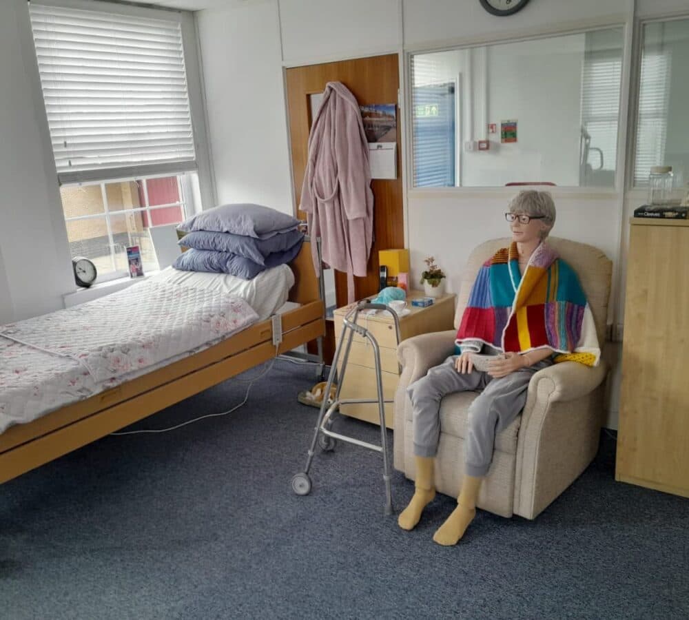 A mannequin sitting on a couch inside a room
