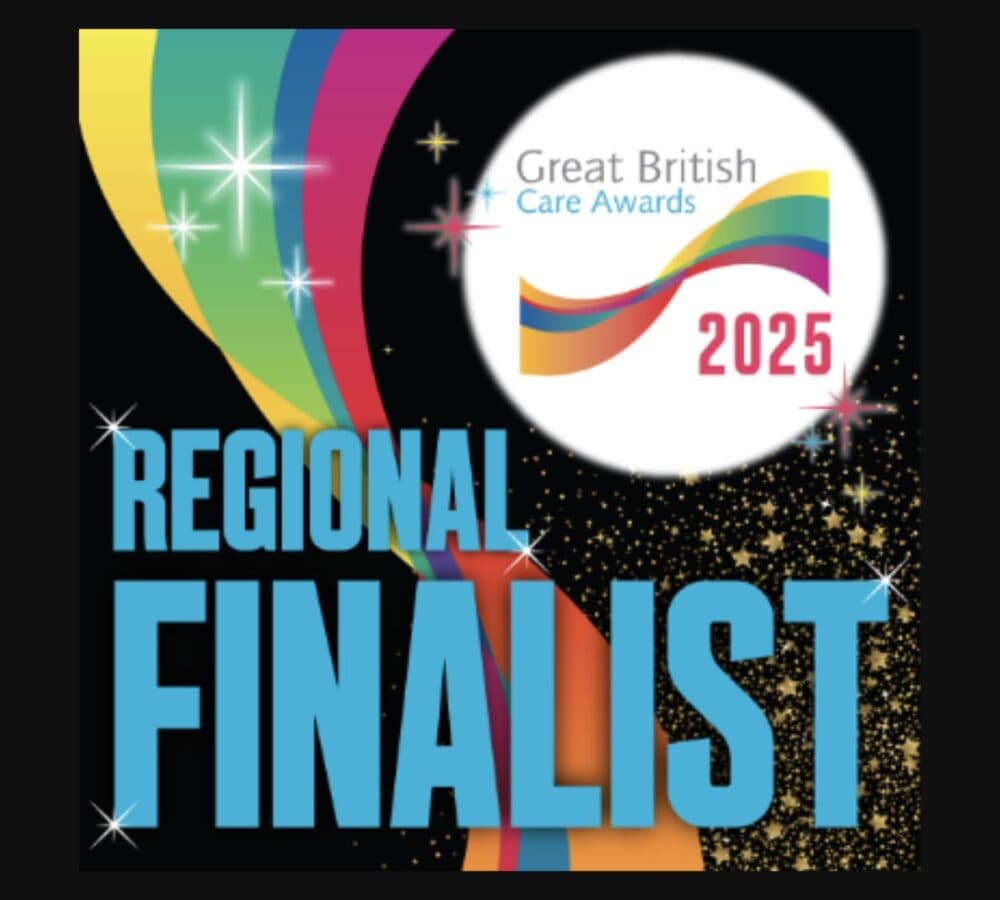 Colorful ribbon with "Great British Care Awards 2025" and large blue "Regional Finalist" text on black background. - Home Instead
