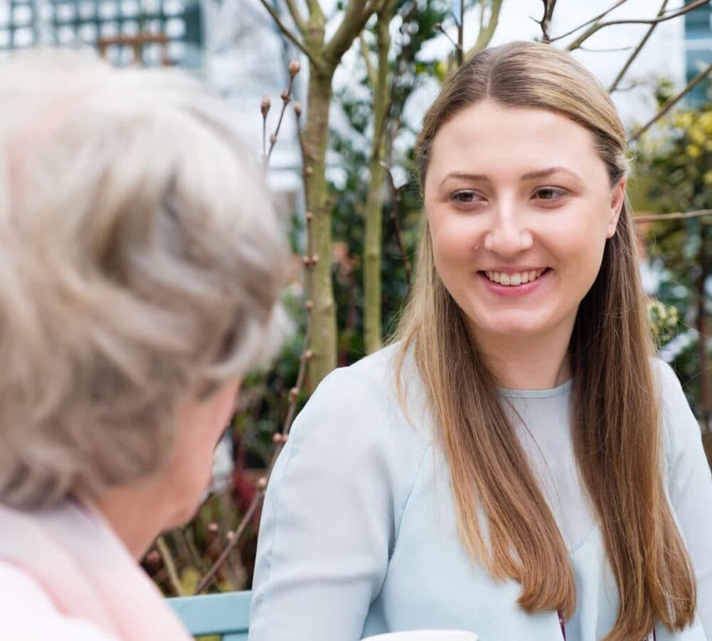 A woman with long blonde hair happy and smiling