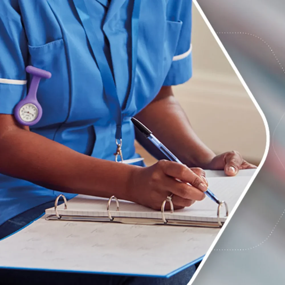 Nurse recording patient notes