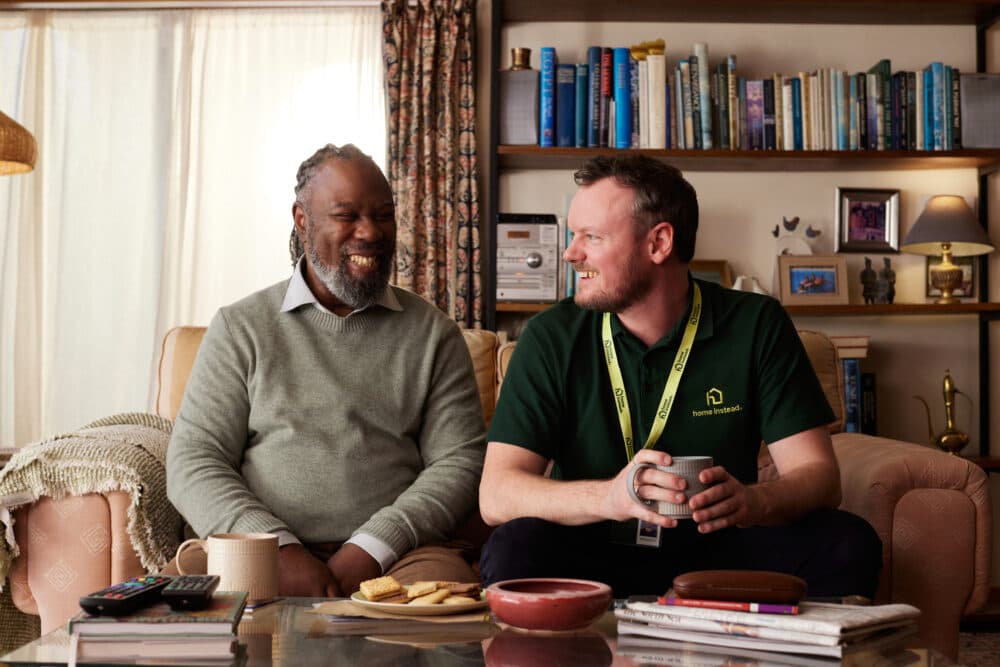 Care Professional and client on sofa.