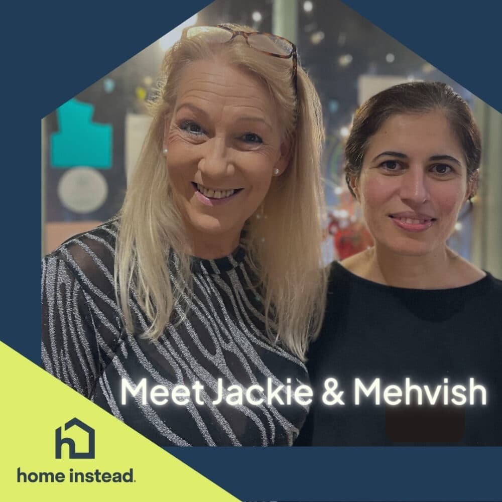 Two women smiling, standing together with "Meet Jackie & Mehvish" and "home instead" text overlayed. - Home Instead