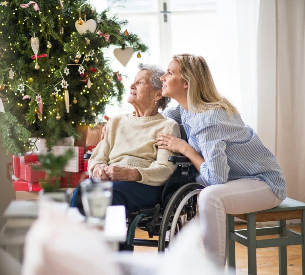 Two women both happy and smiling whole looking at the window