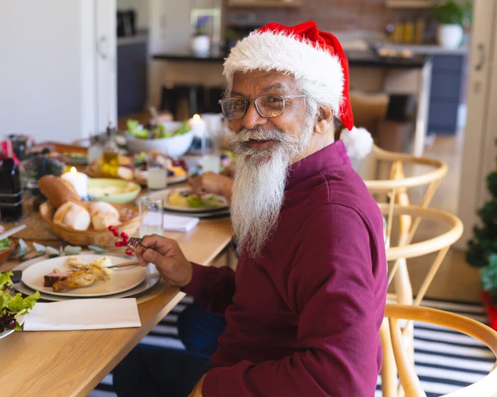 Elderly man with dementia enjoying a Christmas meal presented in a simple, caring way