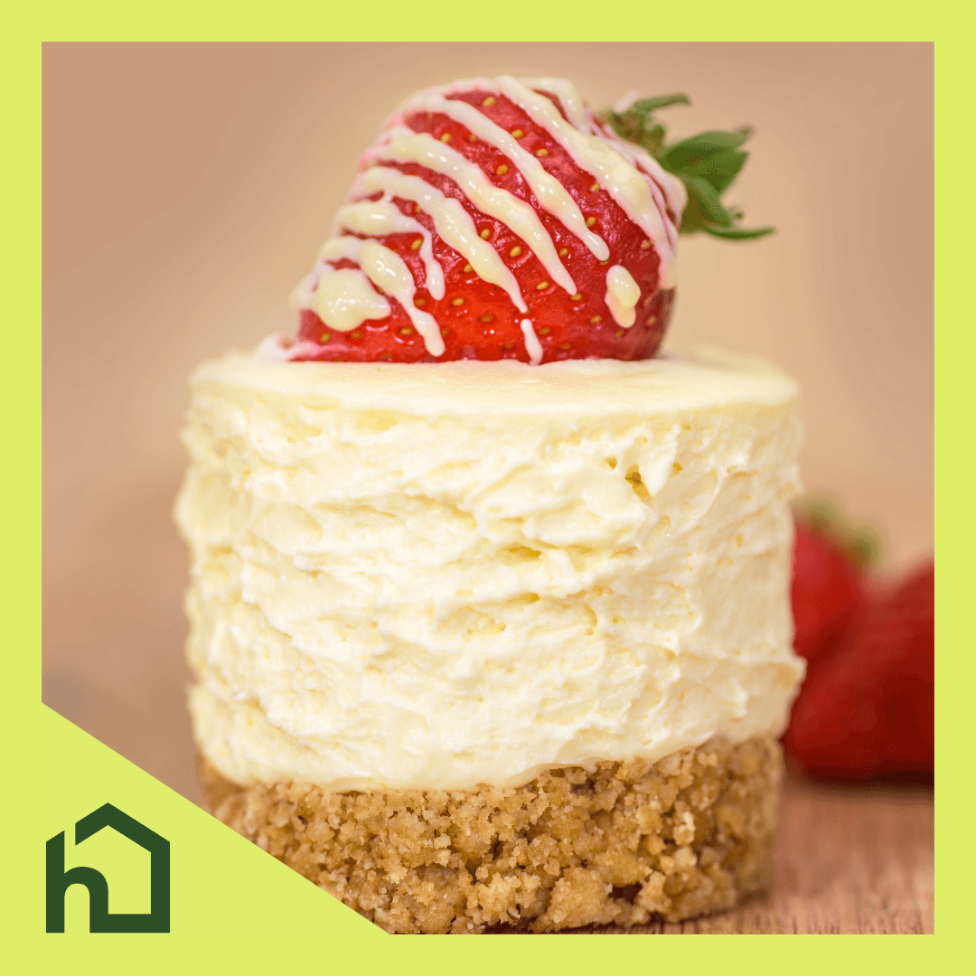 A picture of a small, round, cheesecake with a strawberry on top of it bordered with some Home Instead branding.