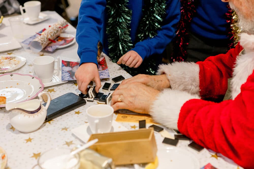 child and elderly person playing domino with each other at the Braintree Community event