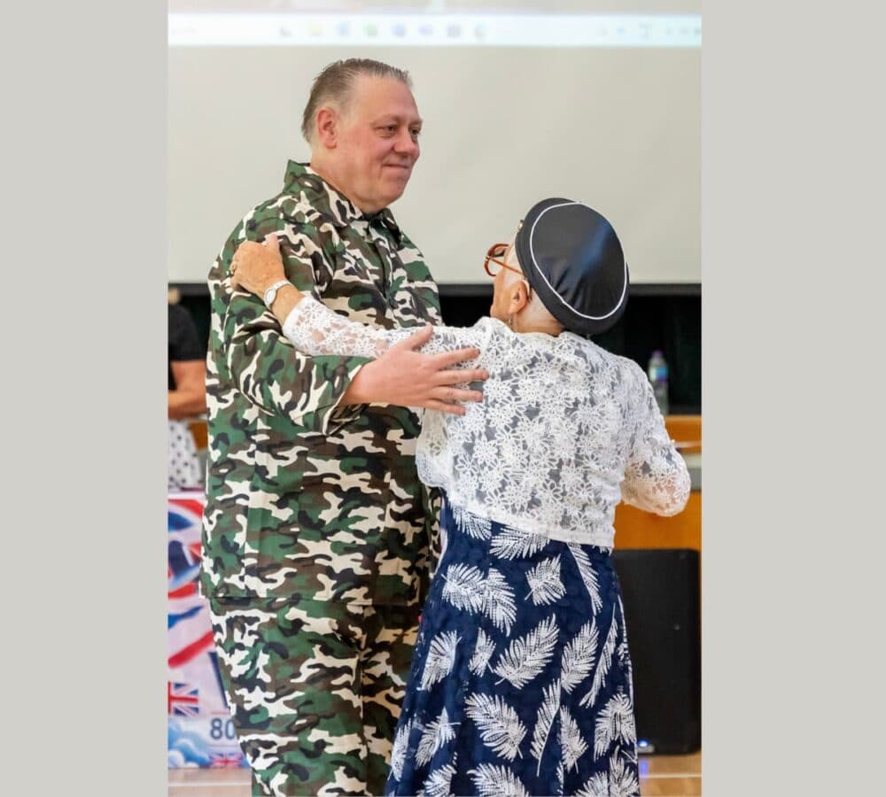 Two people smiling and dancing together