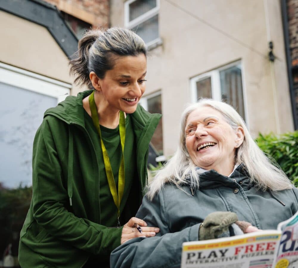 Two women chatting and smiling outdoors