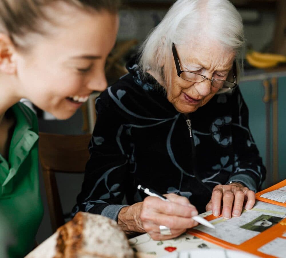 Two women happy and smiling while doing crafts together