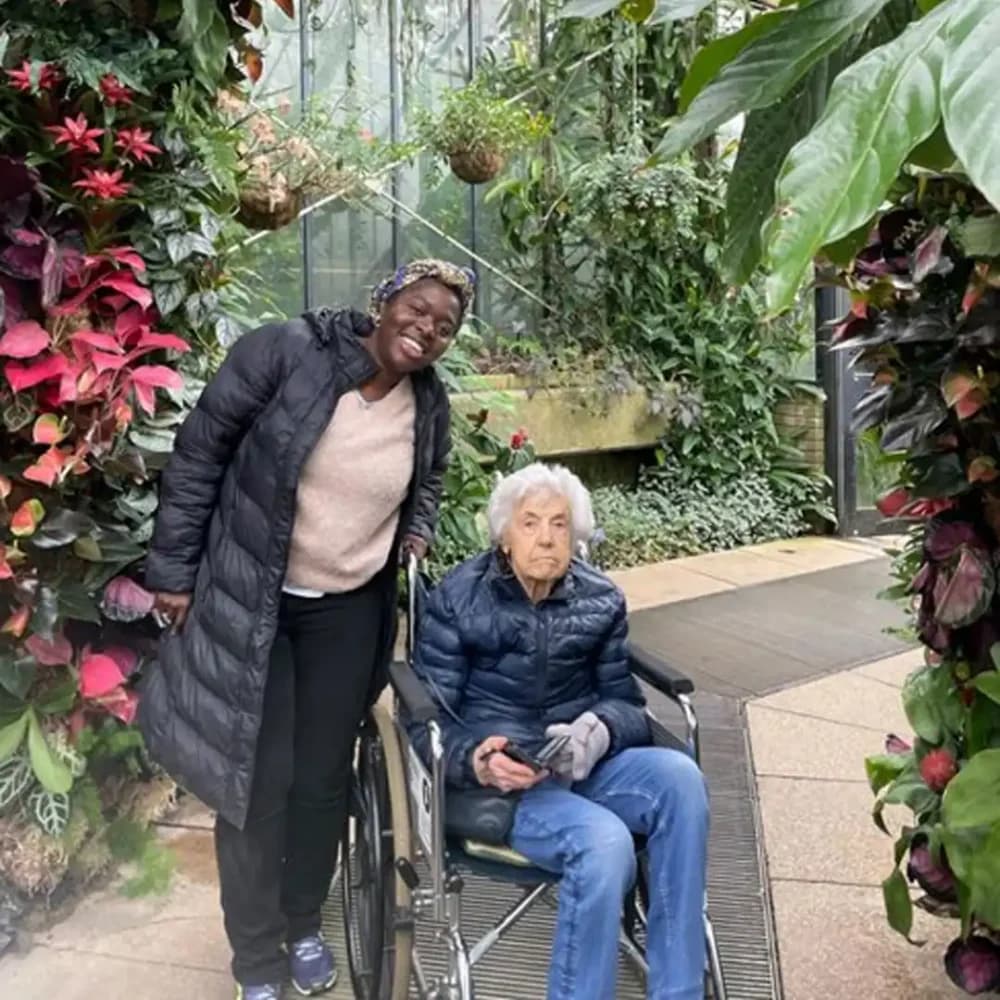 Home Instead Watford Live In Care client Mrs K with her care pro Grace at Kew Botanical Gardens