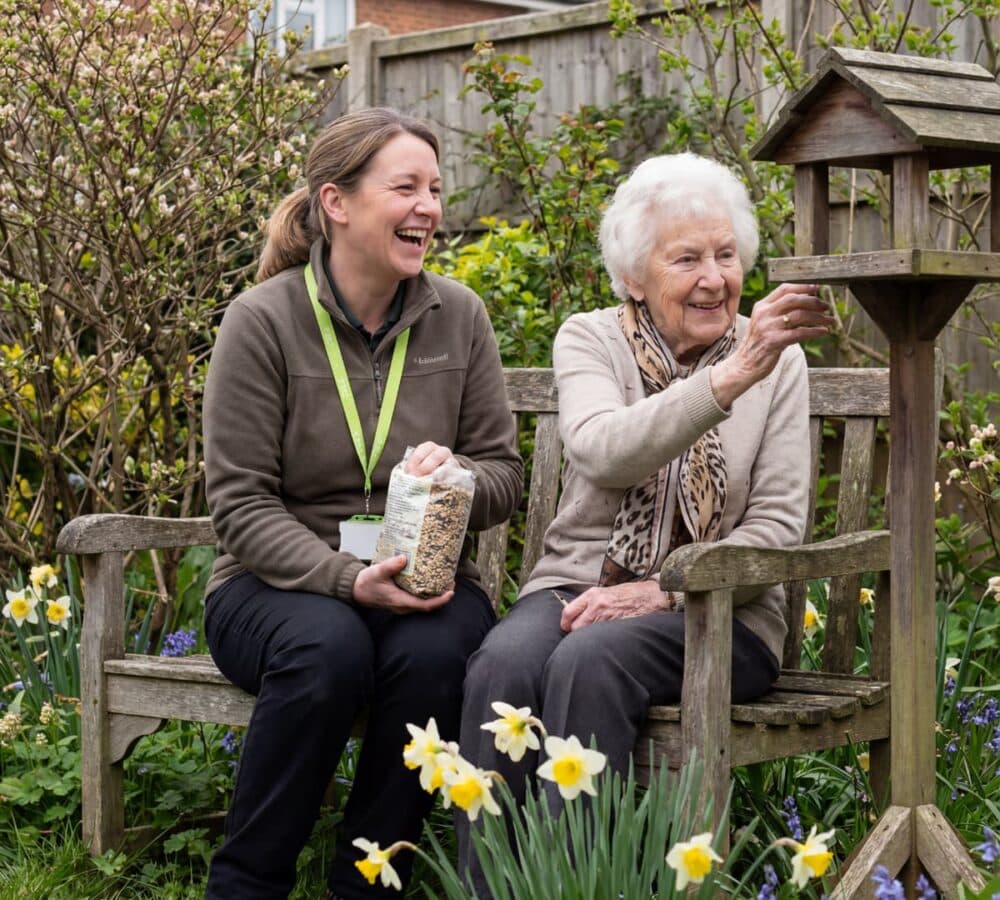 Two women feeding birds outdoors