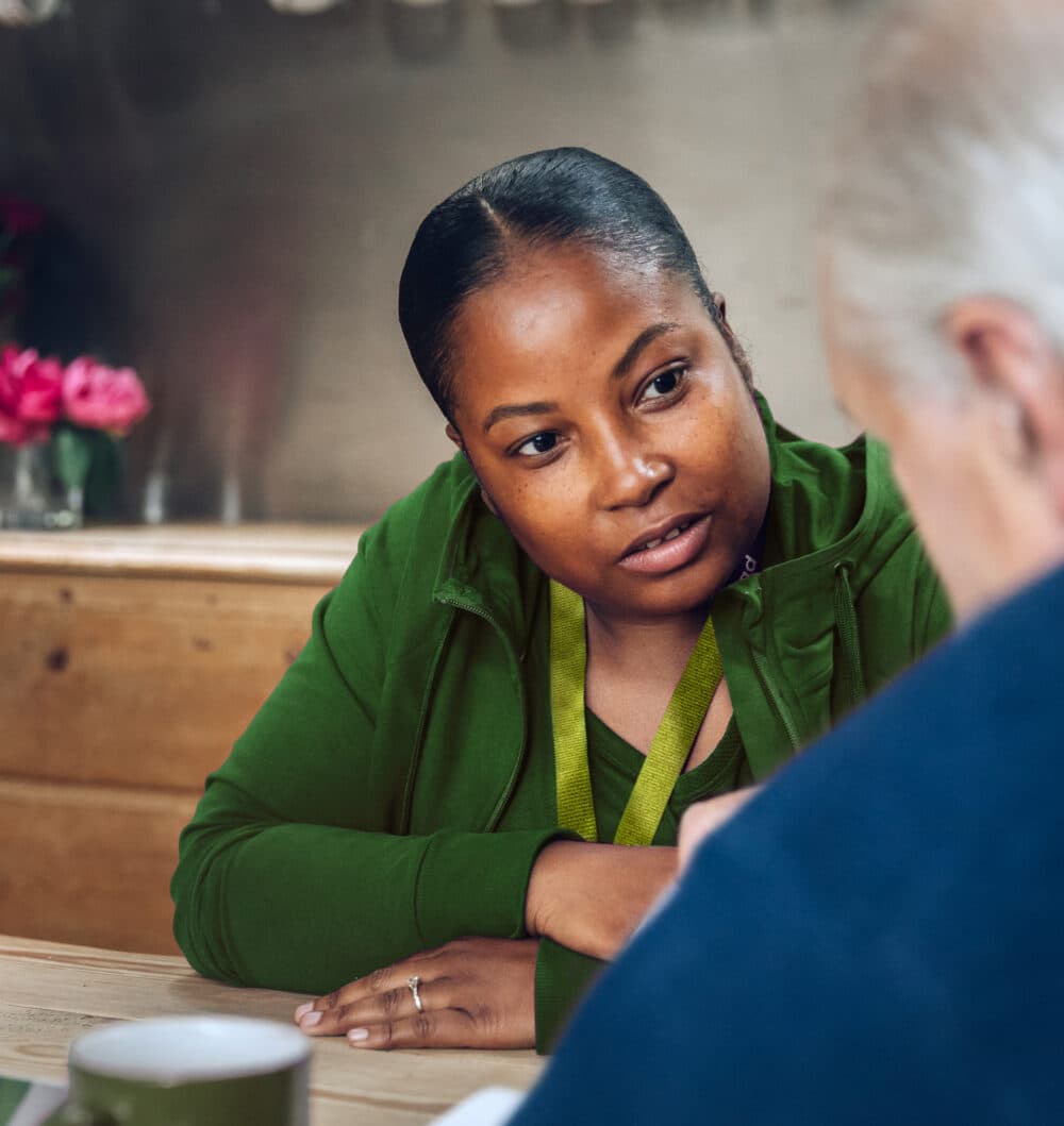 A Care Professional listening intently to an older man talking