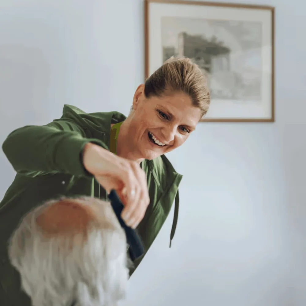 Home Instead Care Professional brushing clients hair