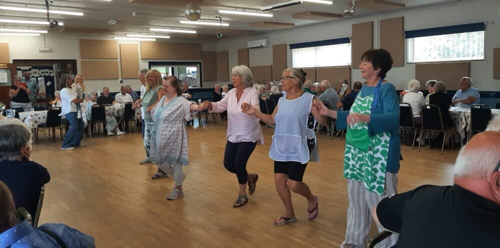 Guest and volunteers enjoy a dance