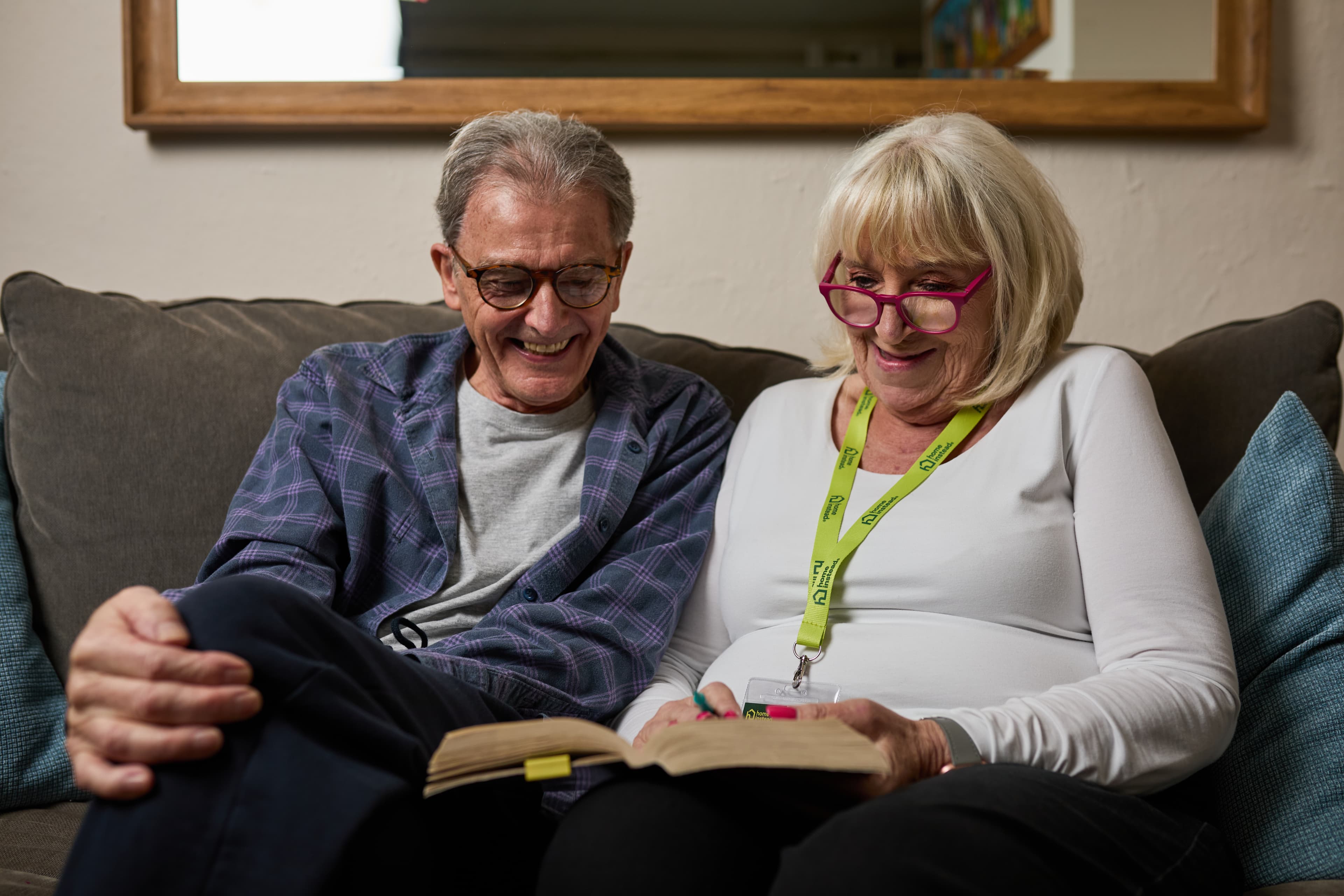 Care Professional looking at a book with her client. Retired from Nursing, Not from Caring