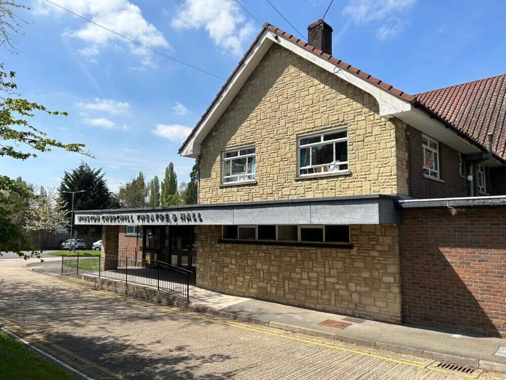 A building with a sign reading "Upper Norwood Methodist Hall" under a sunny sky, with a tree visible to the left. - Home Instead