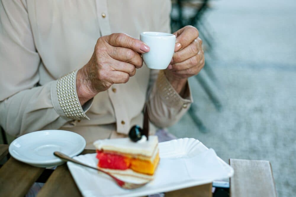 Older lady withe tea and cake in Cardinham Woods cafe