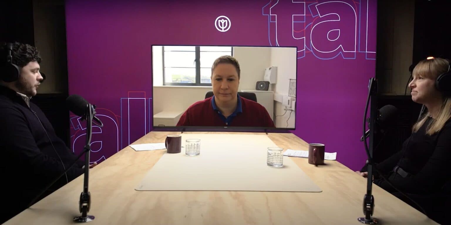 Three people record a podcast, two in-studio and one joining remotely, with microphones on a purple set. - Home Instead
