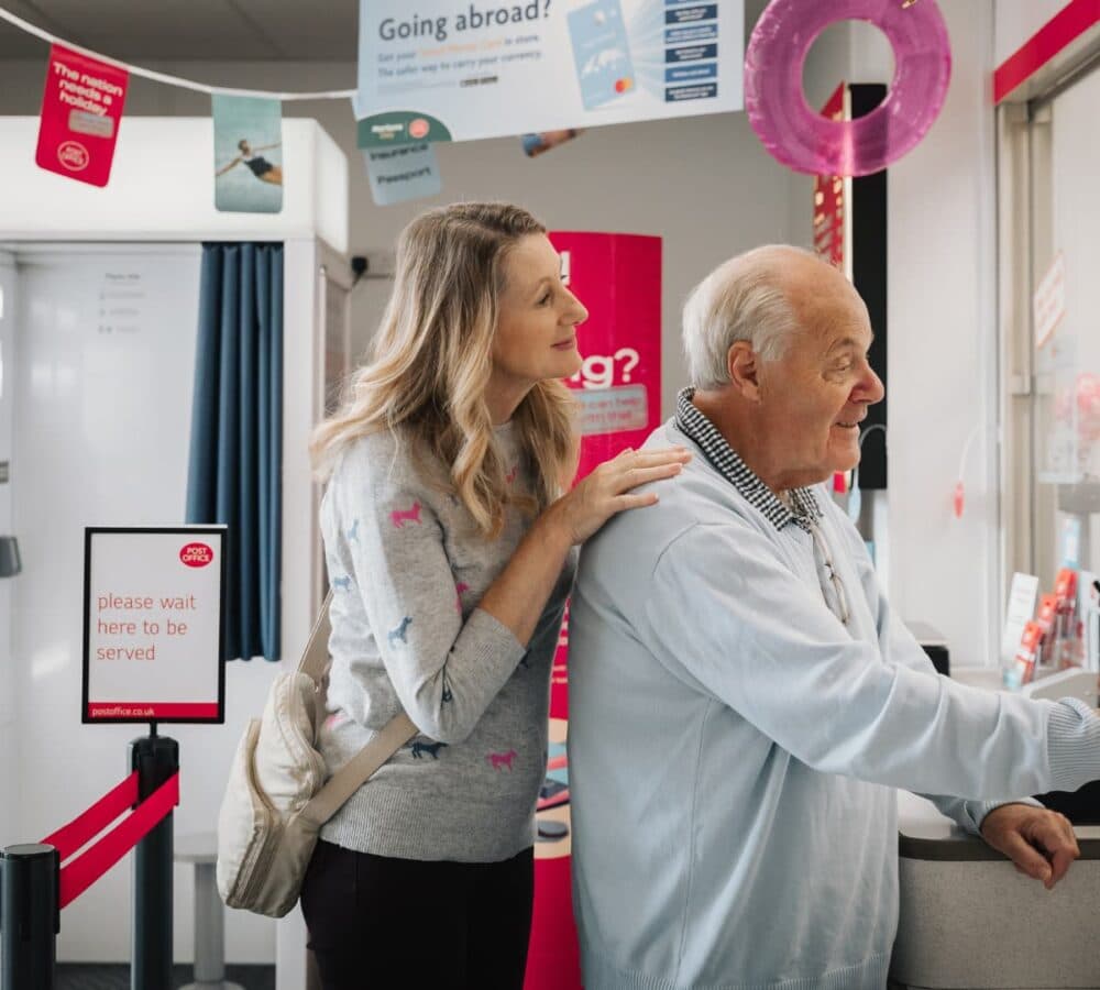 Home Instead Poole Care Professional with client at Post Office.