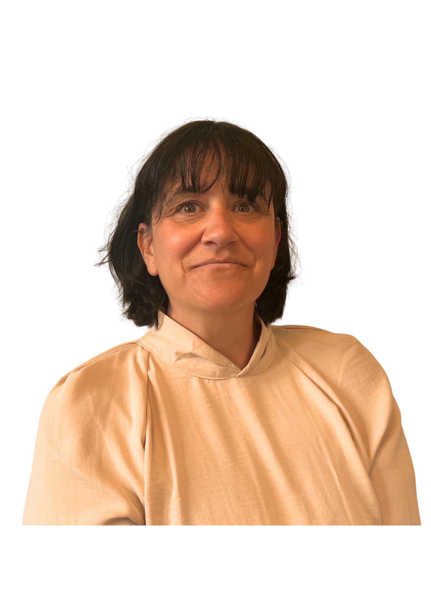 Woman with shoulder-length dark hair and fringe, wearing a beige top, smiling against a white background. - Home Instead