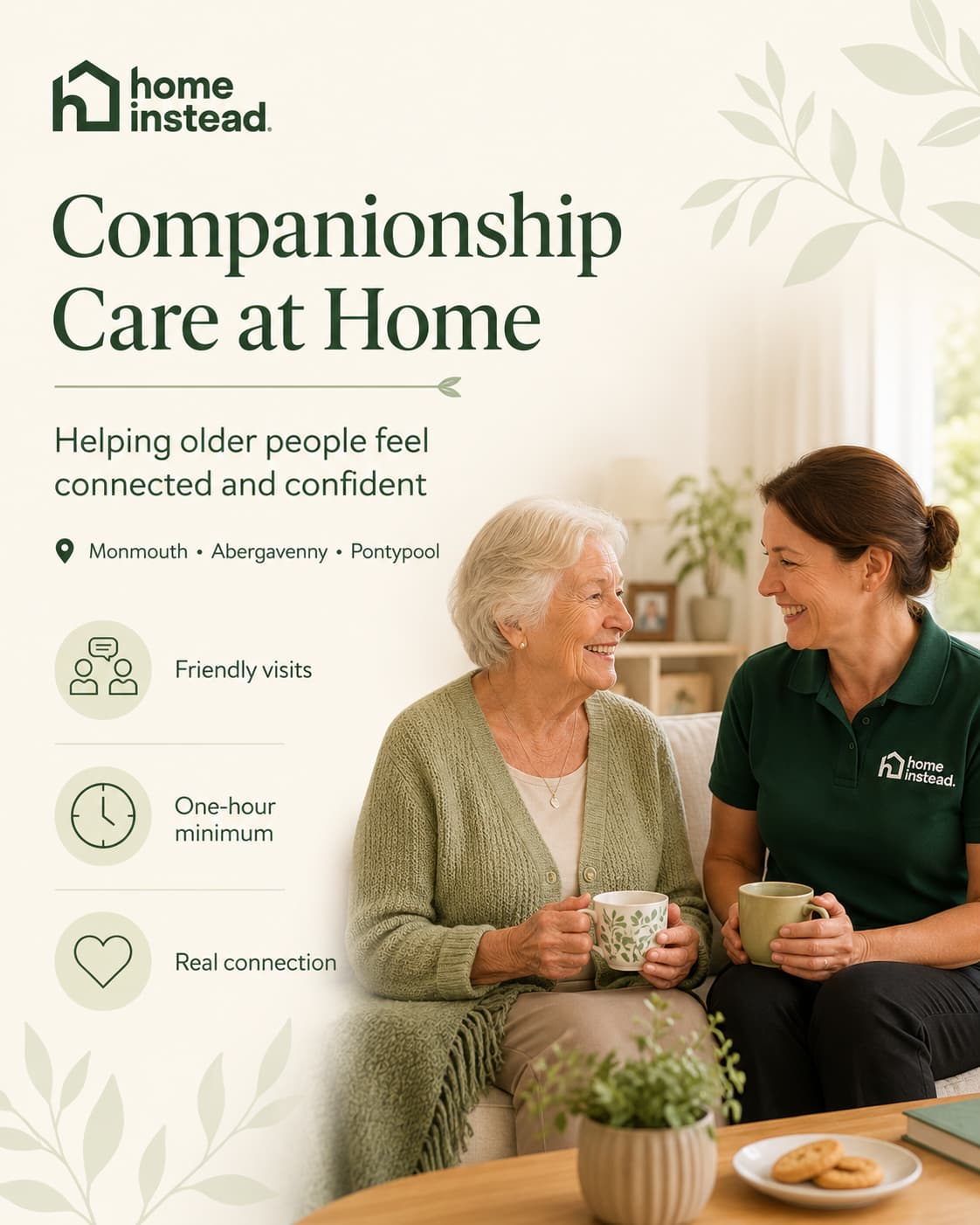 Two women smile and have tea together on a sofa, promoting home companionship care for older people. - Home Instead