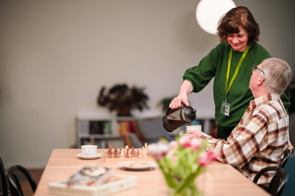 Care pro pouring coffee for the client