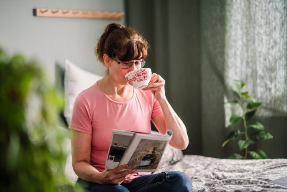 Care Professional reading while drinking tea - Home Instead