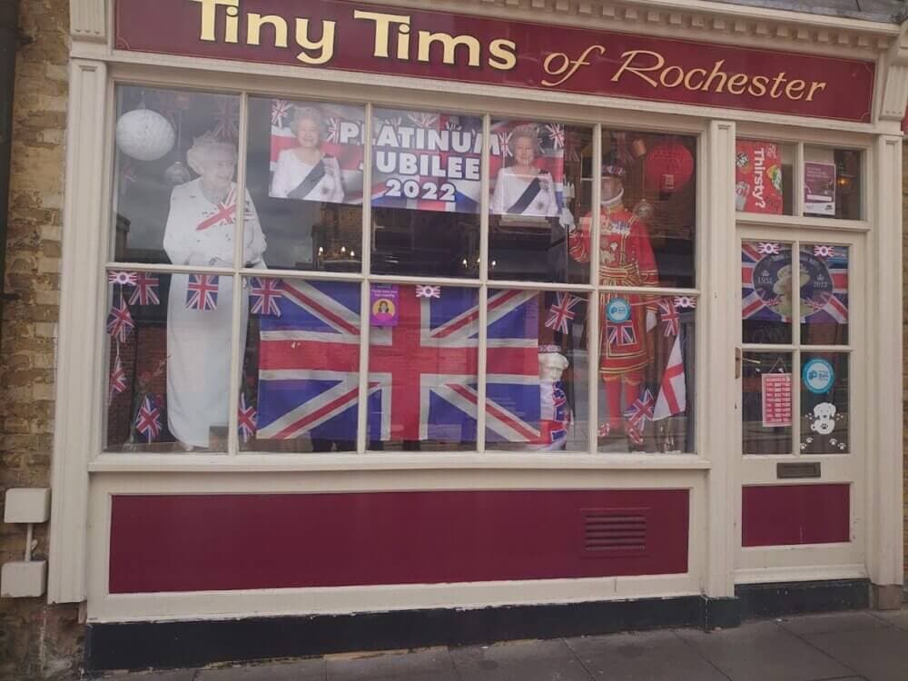 Shop window of Tiny Tims of Rochester decorated with British flags and images celebrating the Platinum Jubilee 2022. - Home Instead