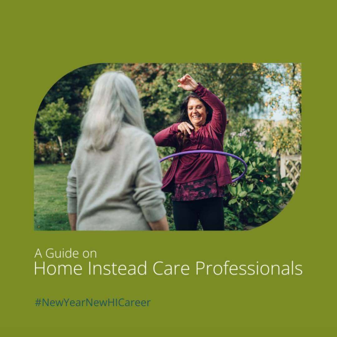 Care Professional showing elderly woman how to hula hoop in their garden. Image is promoting "A Guide on Home Instead Care Professionals". #NewYearNewHICareer.