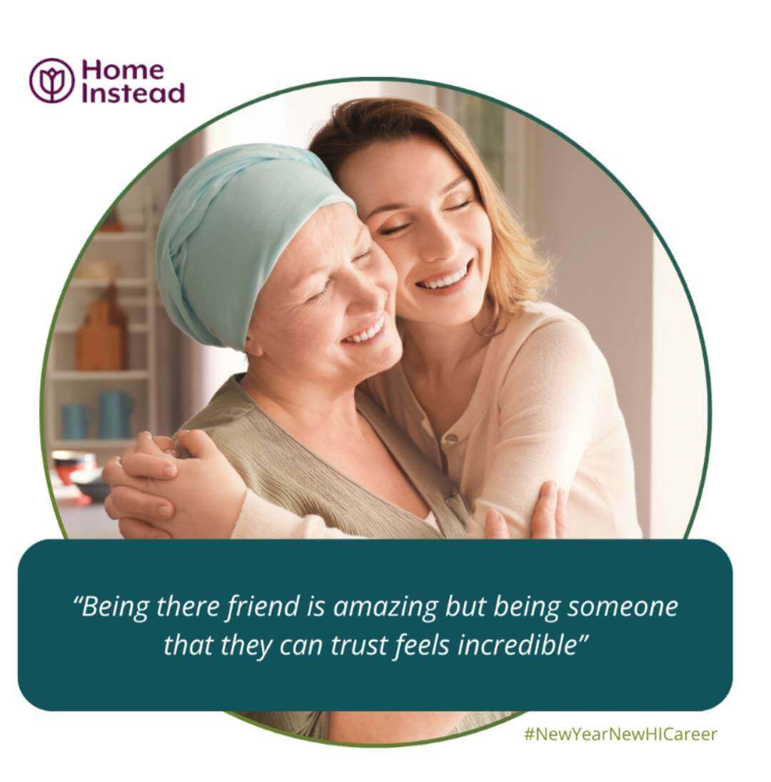 A caregiver and elderly woman share a heartfelt hug, both smiling warmly. Text: “Being there friend is amazing... - Home Instead