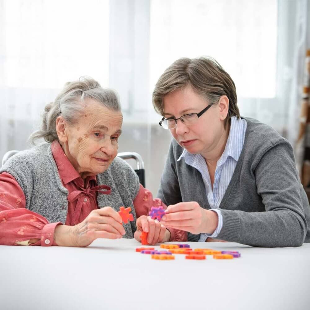 care professional making a jigsaw with a client