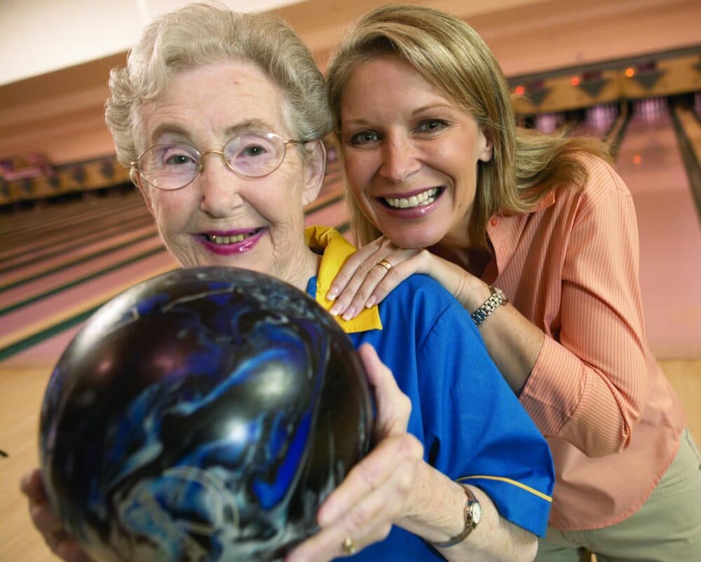 Home Instead client and her daughter at a bowling alley