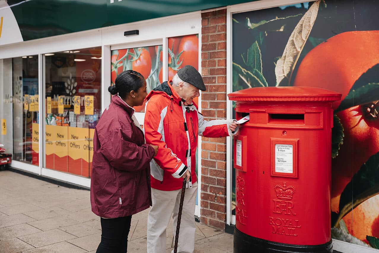 care professional helps her client to send off a postal vote for the local and national election in England_ Home Instead Braintree