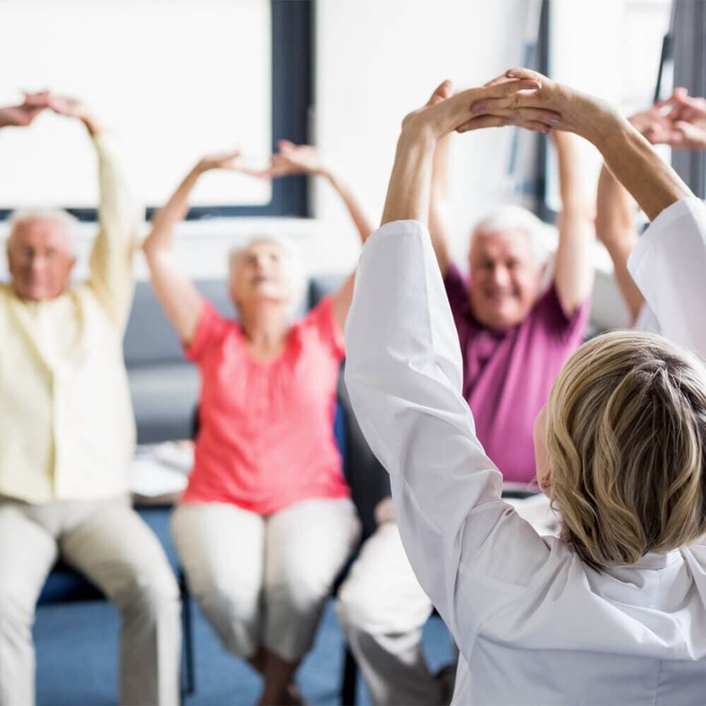 group of seniors enjoying a seated exercise class