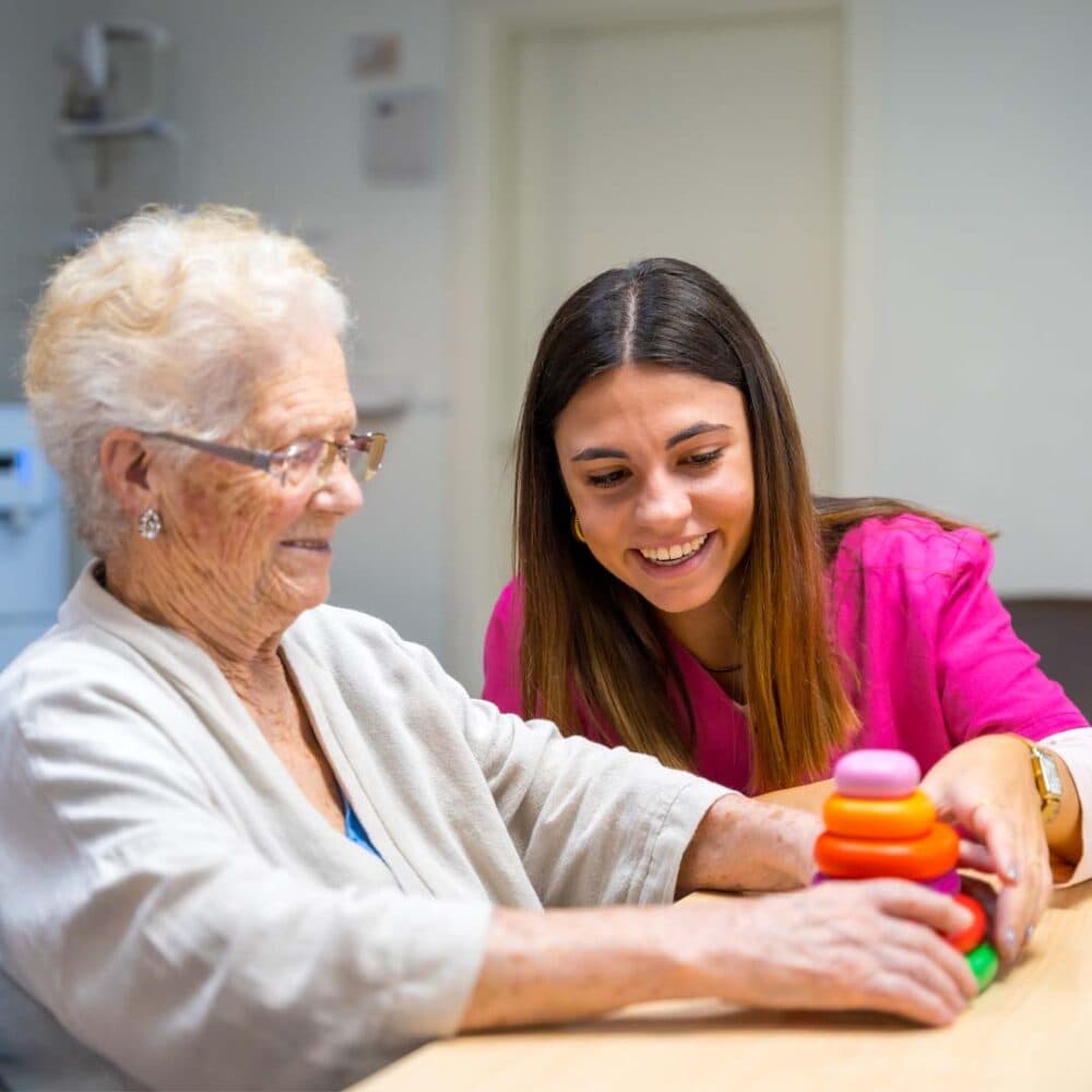 care professional supporting her client with brain training exercises