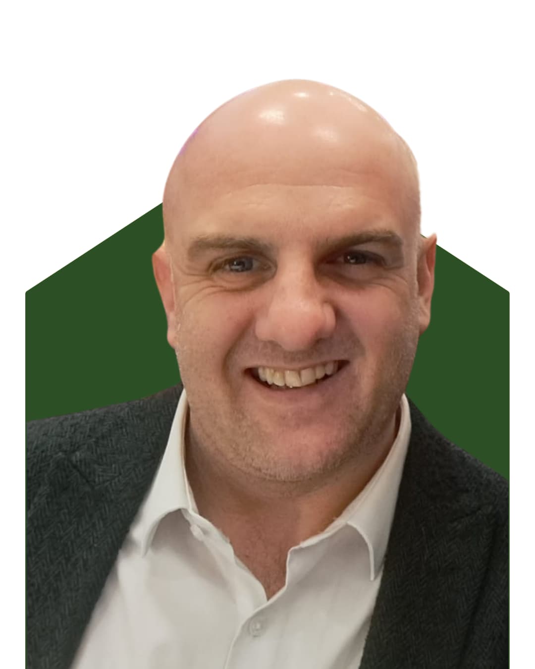 Smiling bald man in a suit jacket and white shirt on a green and white background. - Home Instead
