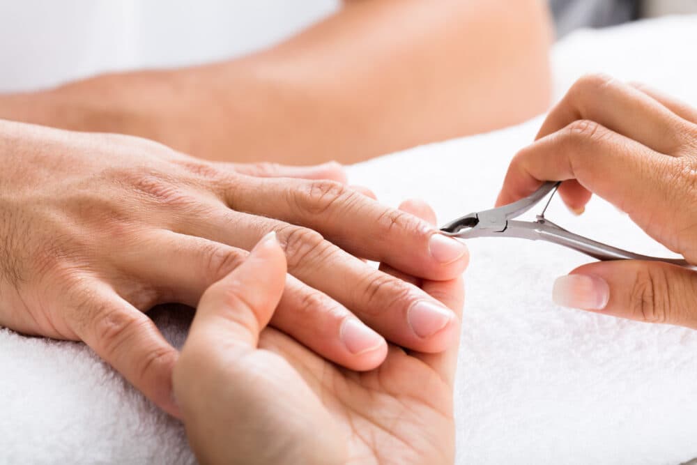 Close-up,Of,A,Manicurist,Cutting,Off,The,Cuticle,From,The - Home Instead
