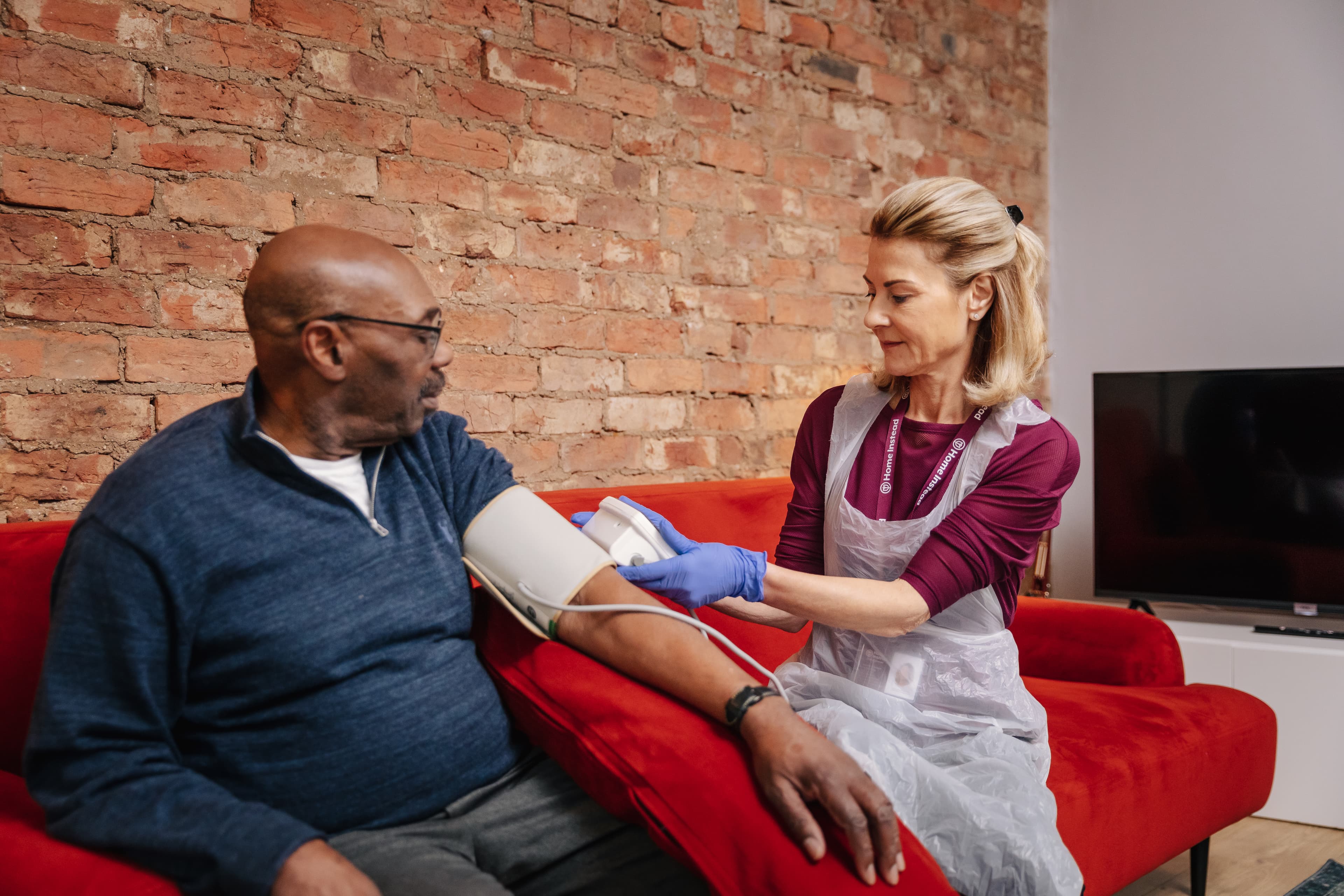 Male client female Care Pro vital signs monitoring blood pressure