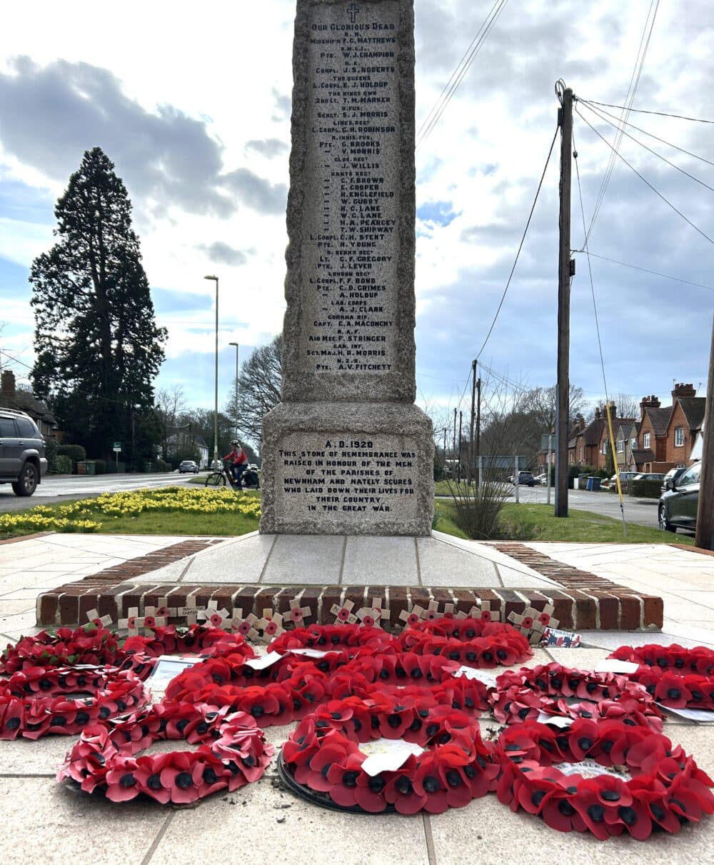 War memorial in the centre of Hook listing soldiers from the area who died in the two world wars, with recently laid wreaths.
